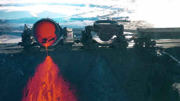 Melted Copper Pouring From a Massive Tank Located Outdoors alt