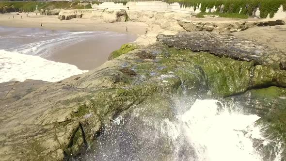 Wave splash on rocks on beach. An almost empty beach. Fantastic aerial view flight pull in drone foo alt