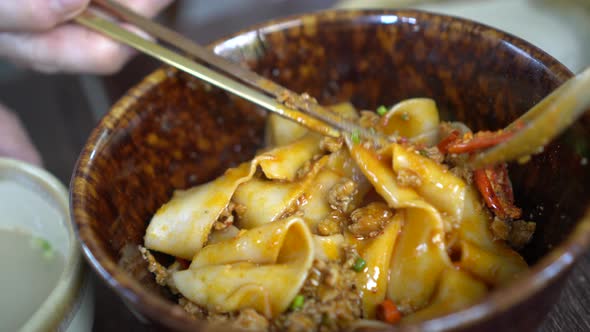 Mixing Dry Chinese Thick Rice Noodle With Chilli And Spicy Red Oil Minced Pork Beef Traditional Food