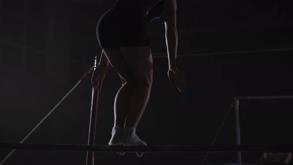 Junior Female Gymnast is Performing on Uneven Bars in Sports Hall Adolescent Sporty Girl alt