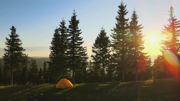 Aerial View of Tourist Camping Tent on Mountain Campsite at Bright Sunny Evening alt