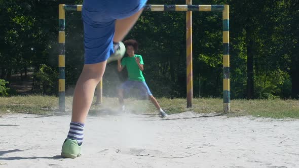 Male Teenager Kicking Football, Goalkeeper Missing Ball, Street Competition