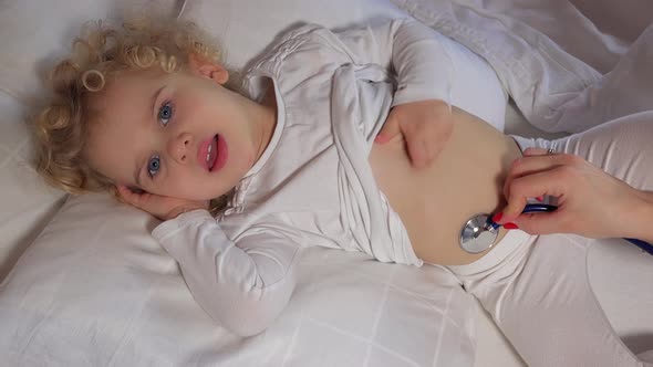Doctor Hand Auscultating Child with Stethoscope in Bedroom