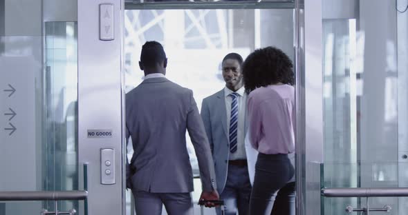Business people getting in the elevator at modern office 4k alt