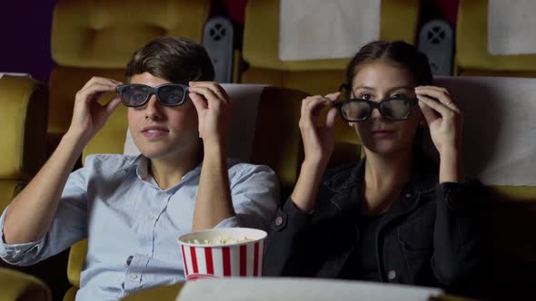 Loving Couple Man and Woman Watch a Boring Movie alt