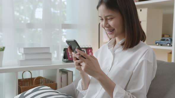 Woman holding a smartphone and using online social on lifestyle alt