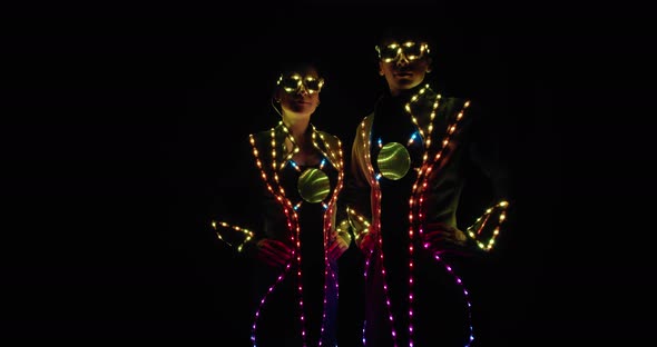 Colorful Lights All Over the Clothes of Two Performers on Stage,  alt