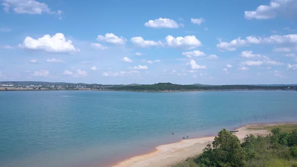 Aerial shots of a lake park in Texas on the popular Canyon Lake while barely any boats are cruising alt