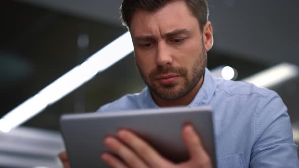 Handsome Businessman Working Tablet Researching Corporate Software in Office alt