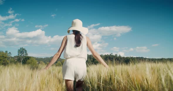 Happy Romantic Woman Walk and Run Through Wheat Agricultural Field alt