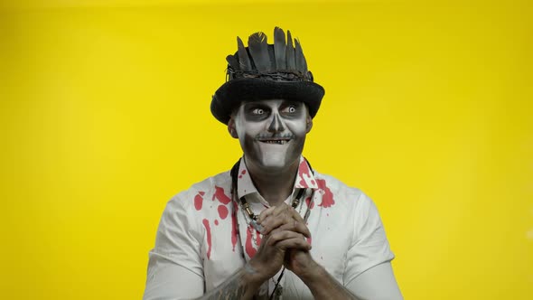 Man in Skeleton Halloween Costume. Cunning Guy in Creepy Makeup with Tricky Face Thinking Prank alt