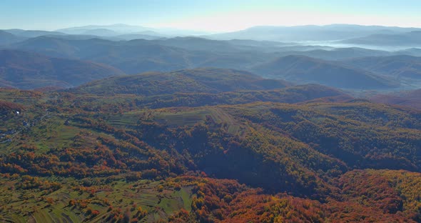 Beautiful in Autumn Forest Landscape in the Mountains at View of Hills Covered By Morning Foggy alt