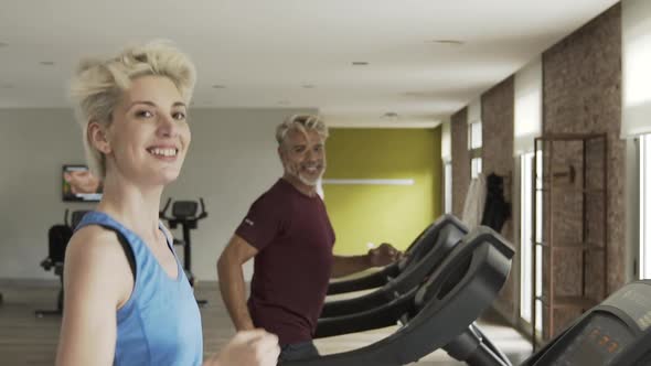 Man and woman exercising in gym