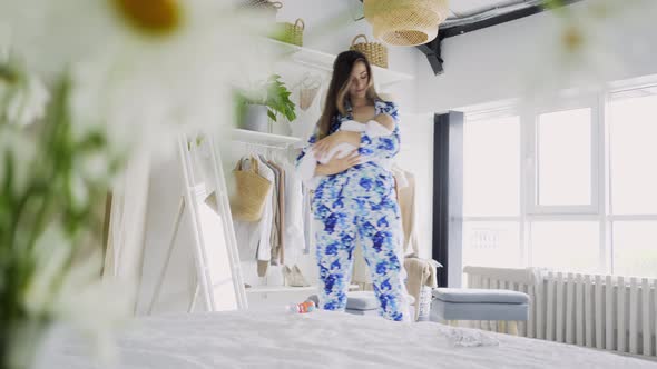 Lady in Pajama Nursing and Breastfeeds Baby