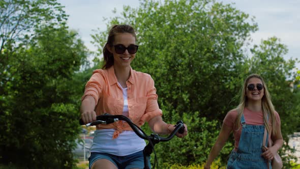 Teenage Girls or Friends with Bicycle in Summer alt