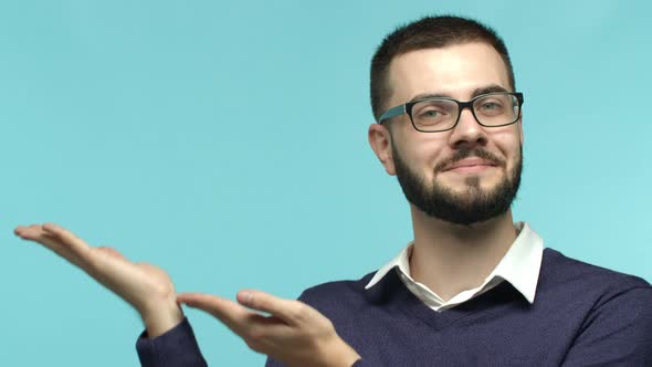 Slow Motion of Handsome Man in Glasses Introduce Product Demonstrate Promo Banner on Hands Pointing