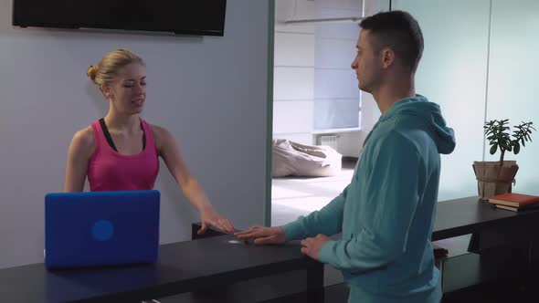 Trainer in Yoga Club Talking with Mixed Race Customer alt