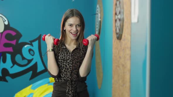 Young Female Lifting Dumbbells, Woman Working Out, Happy Face alt