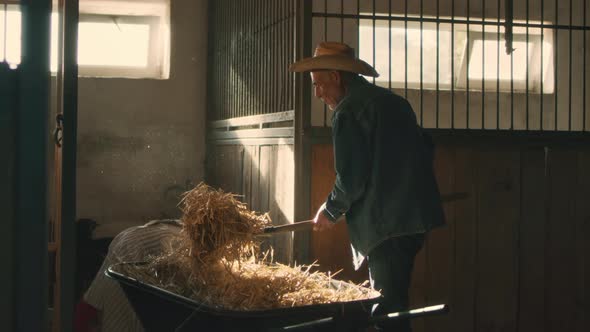 Grandfather and Granddaughter Giving Hay to Goats alt
