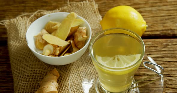 Lemon tea with ginger and lemon on wooden table 4k alt
