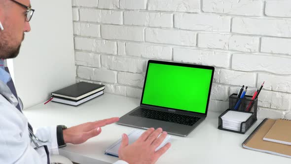 Doctor looking green screen laptop talk soothes patient with breathing technique alt