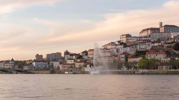 Timelapse of Coimbra at sunset with color light fountain in mondego river, in Portugal alt