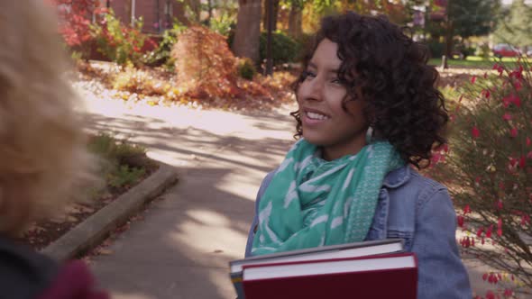 Two college students on campus walking together