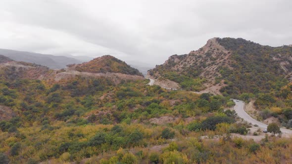 Aerial View Automobile Driving Up Hill In Caucasus Mountains alt