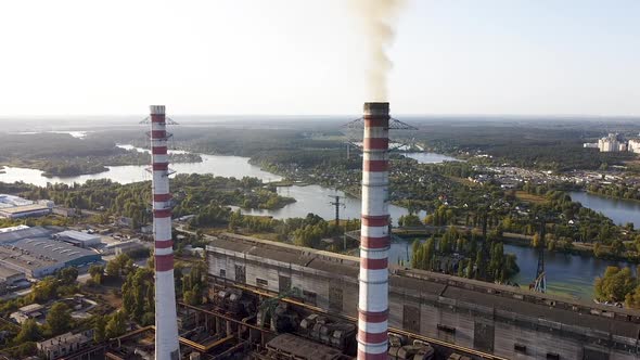 Environmental pollution by industrial plants throwing out harmful smoke from the chimney alt