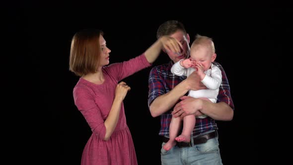 Mother and Father Holding Her Child and Playing with Him. Black alt