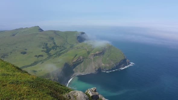 Traveler Standing on Edge of Shikotan Island and Looking on Pacific Ocean, Russia.