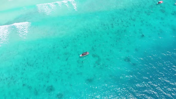 Aerial View of Fishing Boats Swaying on the Waves Off a Paradise Beach Zanzibar alt
