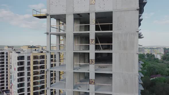 Aerial view of high residential apartment building under construction. Real estate development. alt