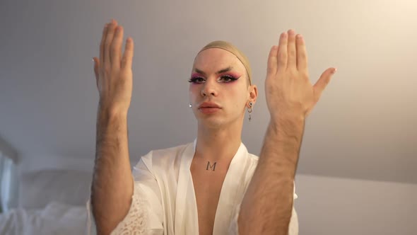 Extravagant LGBT Woman Opening Eyes with Makeup and False Eyelashes Shaking Hands Looking at alt
