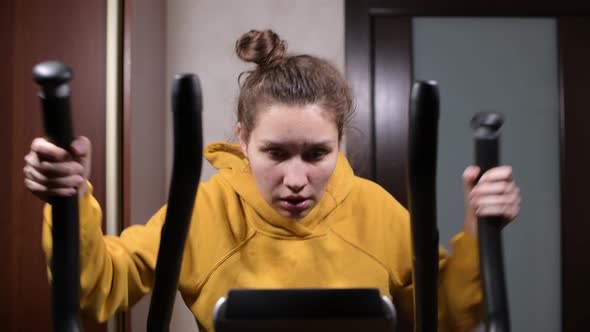 The girl trains, dries sweat with a towel and squeezes a wet towel through alt