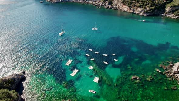 Aerial Drone View to Clear Blue Sea Water with Moored Boats and Yachts alt