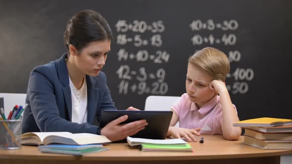 Patient Lady Teacher Explaining Subject on Tablet, Schoolboy Does Not Understand alt