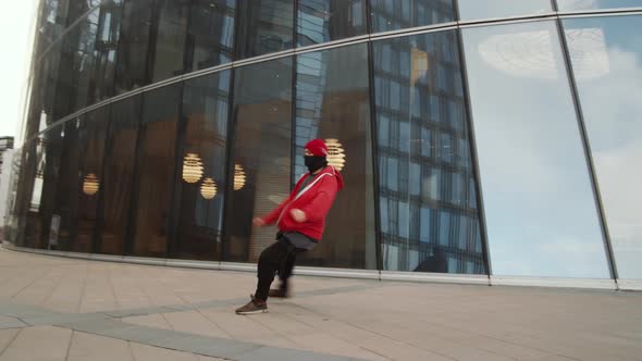 Young Man Doing Parkour Tricks while Working Out Outdoors in the City alt