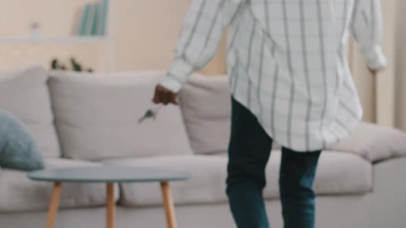 Closeup Apartment Keys Young Happy African American Woman Goes Amusingly Falls on Sofa Rejoices in alt