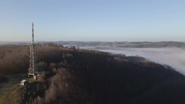 The observation tower of Morsbach in North Rhine-Westphalia, Germany during a foggy sunrise. Aerial alt