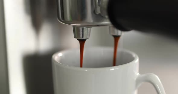 Close Up of Pouring Coffee Stream From Machine in Cup