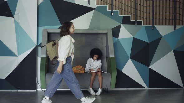African American Pupil Sitting Bench School Hallway alt