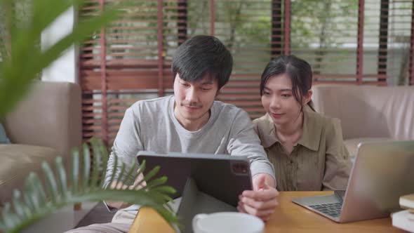 home finance,husband and wife discussing paper bill receipt from tablet laptop