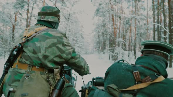 Slow Motion Reenactors Dressed As World War II German Wehrmacht Infantry Soldiers Driving Old Tricar alt