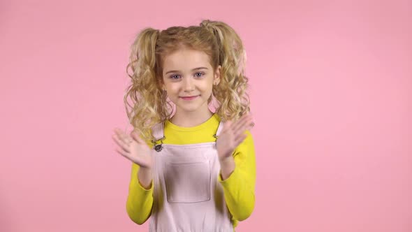 Lovely Blond Curly Girl Is Clapping Her Hands. Slow Motion alt