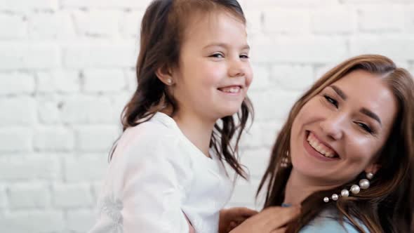 Loving Tender Young Mum Holding Adorable Cute Girl Daughter Embracing Kissing Small Kid alt