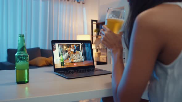 Asia female drinking beer having fun happy moment night party event online celebration via video.