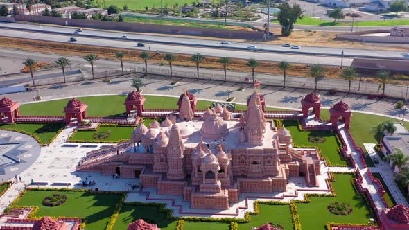 Aerial fast panning left view of a Hindu temple near Los Angeles California alt