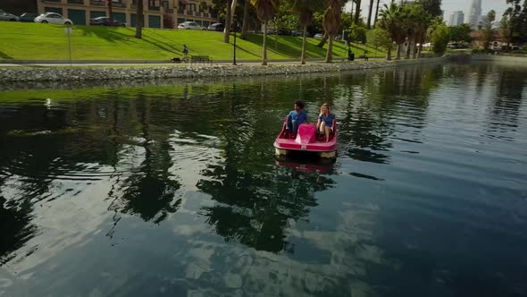 Cute Couple Enjoying A Boat Ride In The Park alt