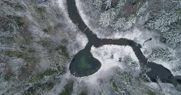 Heart Shape Spring Water Lake in Snow Covered Forest Aerial View Drone Shot alt